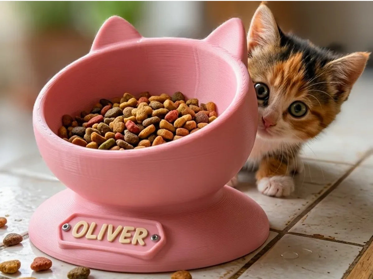Pink personalised cat ear bowl with the name Oliver, calico kitten